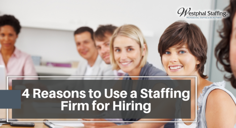 Group of professional workers in a meeting looking at the camera