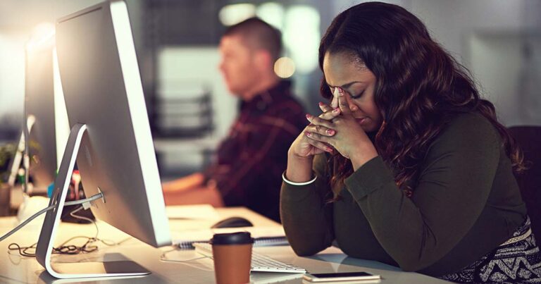 Disappointed employee in front of computer screen