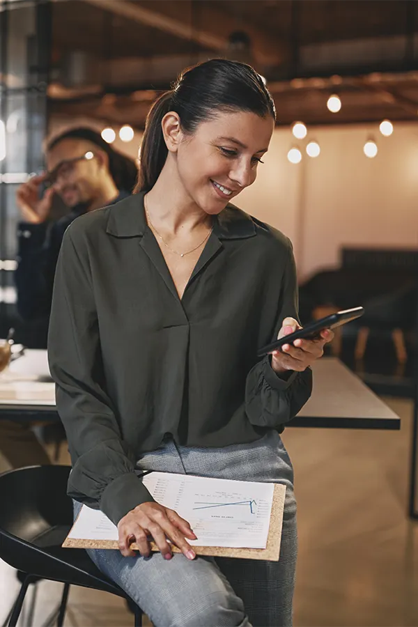 Woman on her phone review documents