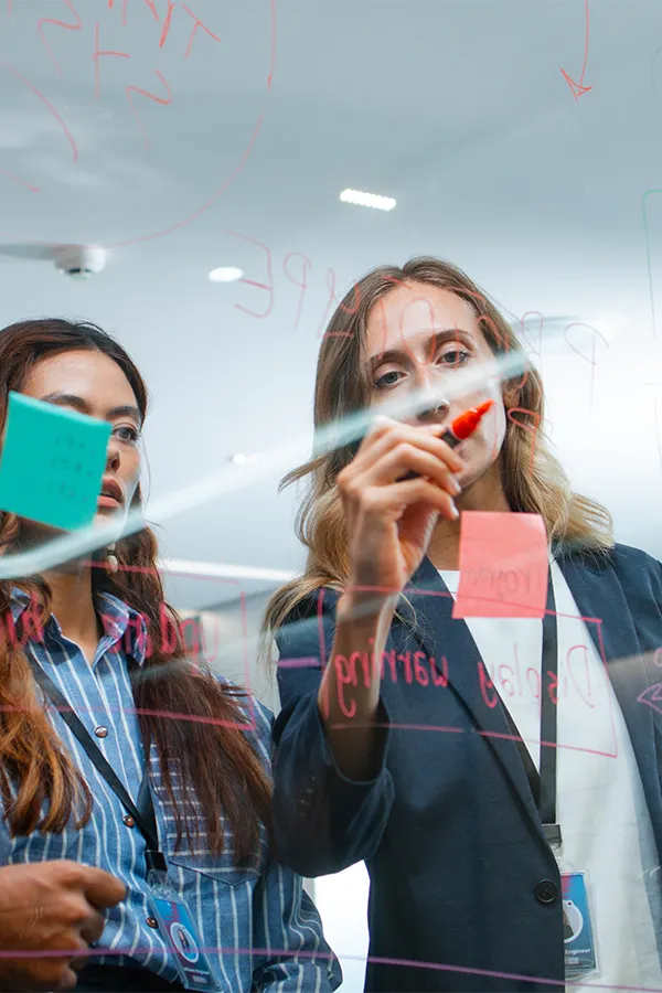 To professional workers planning out with a glass board